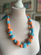 Load image into Gallery viewer, Dolly knot necklace (blue/orange stripe)
